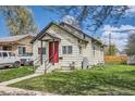Inviting home with a red door, well-kept lawn, and mature trees at 1746 Galena St, Aurora, CO 80010