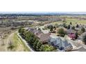 Scenic aerial view showcasing a neighborhood with lush greenery, winding paths, and varied home styles at 14820 E Maplewood Dr, Centennial, CO 80016