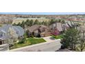 Expansive aerial view of a home with well-manicured lawn, three-car garage, and proximity to open spaces at 14820 E Maplewood Dr, Centennial, CO 80016