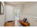 Inviting entryway with hardwood floors and convenient bench seating at 9580 E 5Th Ave, Denver, CO 80230