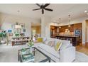 Open-concept living room with modern decor, seamlessly connecting to the kitchen and dining area at 9580 E 5Th Ave, Denver, CO 80230