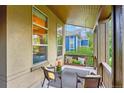 Relaxing porch features comfortable seating and a charming porch swing at 9580 E 5Th Ave, Denver, CO 80230