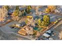 Aerial view of fenced backyard with artificial turf, ample parking, and a shed at 9783 Zephyr Dr, Broomfield, CO 80021