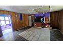 Open-concept living space with wood paneling, tiled floors, and natural light, perfect for customization at 605 Argentine St, Georgetown, CO 80444