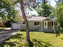 Charming home with a covered front porch and well-manicured lawn with mature tree at 4125 Pierce St, Wheat Ridge, CO 80033