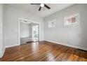 Bright living room showcasing the hardwood floors and a view into the sunroom at 4046 S Bannock St, Englewood, CO 80110