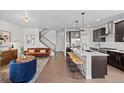 Open-concept living space seamlessly connecting the kitchen, dining, and living areas with modern decor at 6700 Clay St, Denver, CO 80221