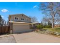 Two-story home featuring a spacious driveway and mature shade tree at 7181 Beech St, Arvada, CO 80004