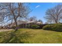 Well-maintained lawn and mature landscaping at 7181 Beech St, Arvada, CO 80004