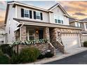 Inviting home showcasing a brick front, an attached two-car garage, and a charming porch with flower boxes at 4545 S Monaco St # 328, Denver, CO 80237