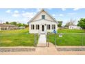 Inviting home exterior featuring a well-manicured front lawn and a charming white picket fence at 276 N 5Th Ave, Brighton, CO 80601