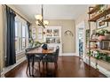 Elegant dining room featuring a wood table, stylish chairs, and a built-in cabinet at 1847 W 41St Ave, Denver, CO 80211