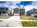 Exterior view of a gray two-story home with red shutters, a two-car garage, and landscaped front yard at 17955 Sky Pilot Ave, Parker, CO 80134