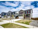 Street view of neighborhood homes with manicured lawns and sidewalks on a sunny day at 17955 Sky Pilot Ave, Parker, CO 80134