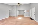 Bright living room with vaulted ceilings, skylight, wood floors, and a view of the adjacent kitchen at 12023 E Harvard Ave # 203, Aurora, CO 80014