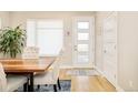 Dining area featuring wood table, four upholstered chairs, and modern decor with ample natural light at 3515 S Ogden St, Englewood, CO 80113