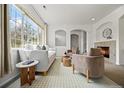 Comfortable living room featuring a fireplace, arched doorways, and large window at 101 Granby Way # B, Aurora, CO 80011