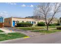 View of the exterior featuring the landscaping and blue doors at 1804 Grove St, Denver, CO 80204