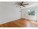 Bright living room with hardwood floors, ceiling fan, and ample natural light from the window at 1804 Grove St, Denver, CO 80204