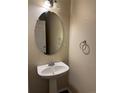 Neat half-bathroom featuring a pedestal sink, neutral wall paint, and chrome fixtures at 20861 E 40Th Ave, Denver, CO 80249