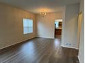 Well-lit living room with hardwood floors, chandelier, and open access to the kitchen at 20861 E 40Th Ave, Denver, CO 80249
