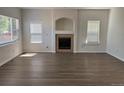 Bright living room features a fireplace, neutral walls, modern floors, and large windows at 20861 E 40Th Ave, Denver, CO 80249