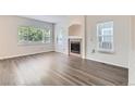 Bright living room with ample natural light, featuring a fireplace and modern gray-toned wood flooring at 20861 E 40Th Ave, Denver, CO 80249
