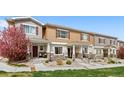 Inviting townhome featuring charming exteriors, landscaped front yard, and private entrances at 871 E 98Th Ave # 1402, Thornton, CO 80229