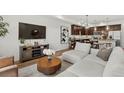 Open-concept living room featuring modern décor, hardwood floors, and an inviting ambiance at 871 E 98Th Ave # 1402, Thornton, CO 80229