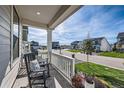 Front porch view of a quiet tree-lined street with other homes at 1173 Williams Loop, Elizabeth, CO 80107