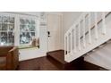Welcoming entryway with a cozy window seat, staircase and lovely hardwood floors at 9661 W Chatfield Ave # B, Littleton, CO 80128