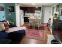 Cozy living space open to the kitchen, featuring an island with seating at 1300 S Parker Rd # 212, Denver, CO 80231