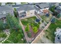 Aerial view of a spacious backyard with a well-maintained lawn, a trampoline, and mature trees at 4145 Manorbrier Cir, Castle Rock, CO 80104