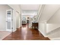 Bright foyer featuring hardwood floors, staircase, and open access to living areas at 4145 Manorbrier Cir, Castle Rock, CO 80104