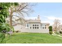 A wide shot of the backyard with a fenced patio, lawn and view of the two-story home at 6858 Zenobia St # 9, Westminster, CO 80030