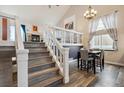 Bright dining area with a table and chairs, hardwood floors, and loft view at 8293 S Ogden Cir, Littleton, CO 80122