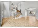 Bright foyer with a grand staircase, hardwood floors, and elegant chandelier at 1795 Eldorado Cir, Superior, CO 80027