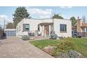 Contemporary home featuring a paved driveway and well-maintained front lawn at 621 Kearney St, Denver, CO 80220