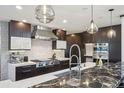 Modern kitchen with stainless steel appliances, stylish backsplash, and marble countertops at 621 Kearney St, Denver, CO 80220