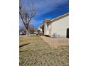 Beige house with stone landscaping and a fenced in backyard at 808 Idalia St, Aurora, CO 80011