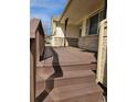 Covered front porch with wooden deck and wooden support beams at 808 Idalia St, Aurora, CO 80011