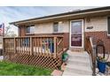 Close-up of the front porch, with seating and decor adding a welcoming feel to the entry at 11398 W Ford Pl, Lakewood, CO 80226