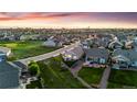 Expansive aerial view of a residential area featuring neatly arranged homes and manicured green spaces at 15604 Xenia Way, Brighton, CO 80602