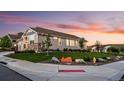 Beautifully landscaped yard with a charming home featuring stone accents and well-manicured lawn at 15604 Xenia Way, Brighton, CO 80602