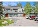 Front view of townhomes with attached garages and parking at 680 S Main St # 19, Breckenridge, CO 80424