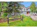 Ornamental bench in a landscaped yard, with homes in the background at 680 S Main St # 19, Breckenridge, CO 80424