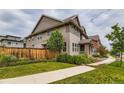 Beautifully landscaped home exterior showcasing a well-maintained lawn and tasteful plantings at 5975 Hanover St, Denver, CO 80238