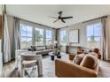 Bright living room with ample natural light, stylish furniture, and modern ceiling fan at 5975 Hanover St, Denver, CO 80238