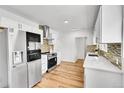 Bright modern kitchen with stainless steel appliances and stylish backsplash at 16130 Mt Vernon Rd, Golden, CO 80401