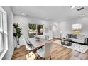 Bright and stylish living room with wood floors, large windows, and neutral decor at 16130 Mt Vernon Rd, Golden, CO 80401